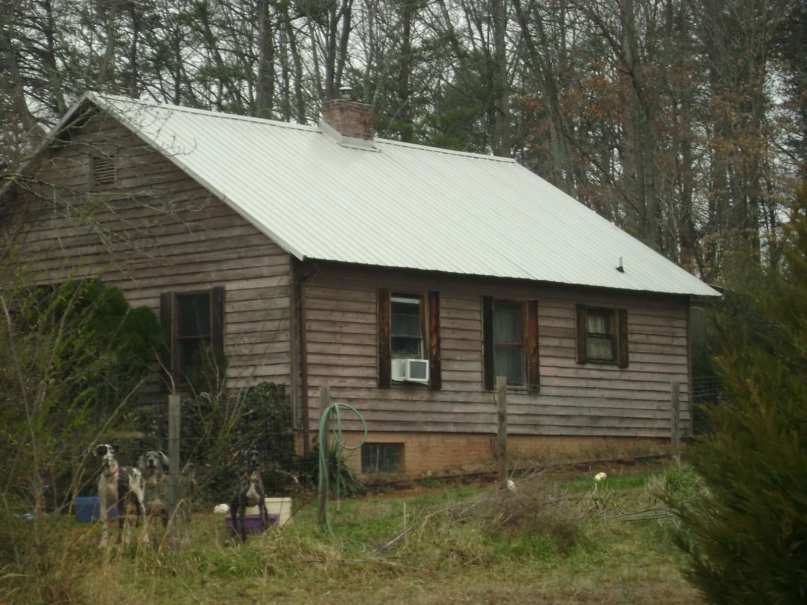 White metal roof on an old wood sided farmhouse, from a Metal Roof Installation job in Union Mills